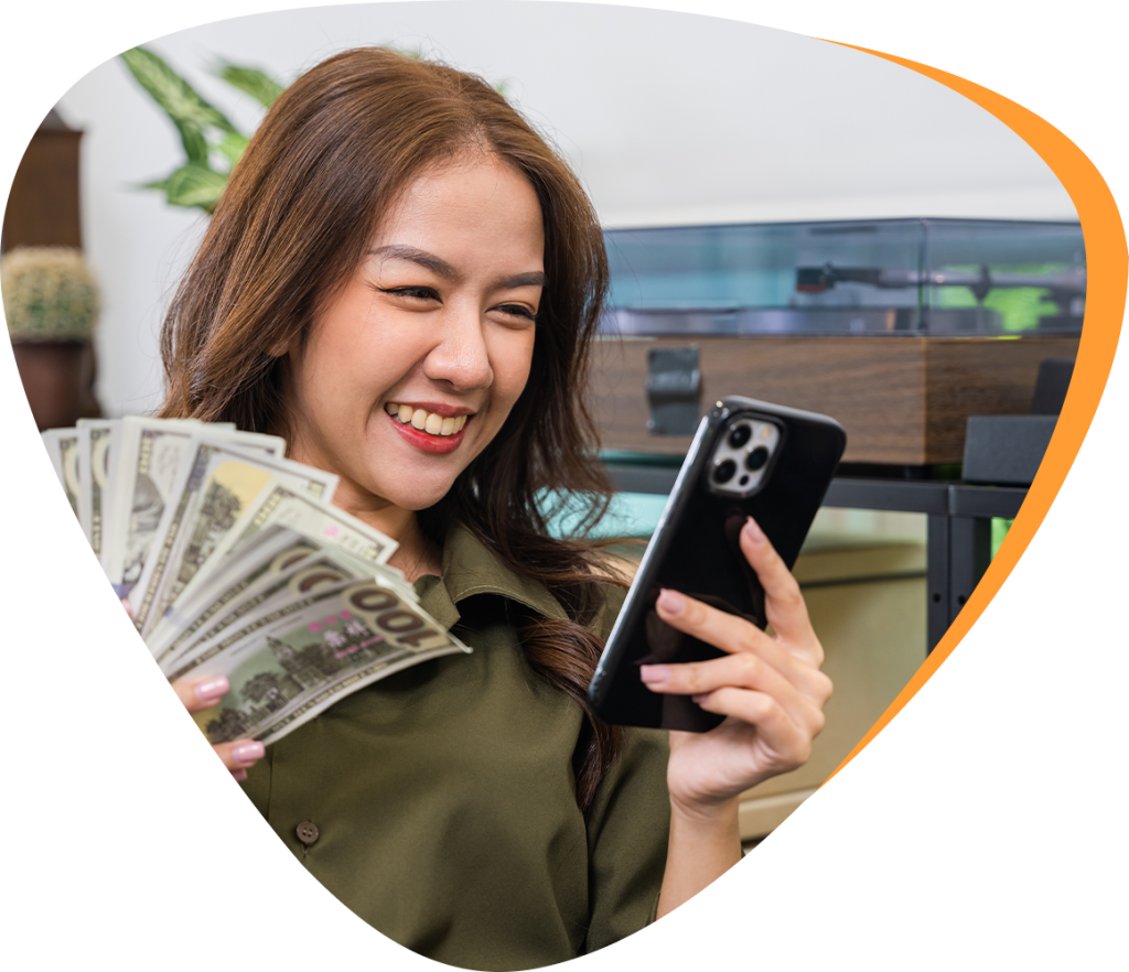 girl smiling at phone while holding cash