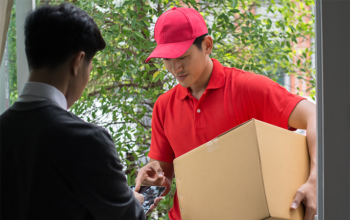 LBC delivery man handing package to customer