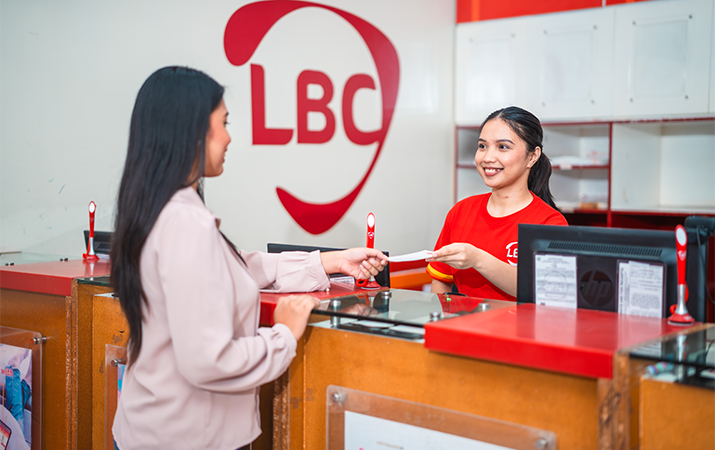 woman dropping off package to a female LBC employee